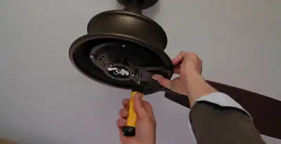Electrician installing ceiling fan mounting bracket and fixture in Pasadena, CA