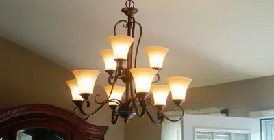 Classic ceiling chandelier installation with warm lighting in Pasadena, CA