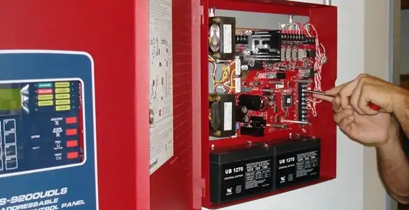 fire alarm installation service showing technician configuring fire alarm control panel in Pasadena, CA