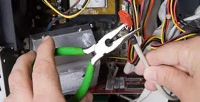 Licensed electrical contractor performing electrical repair with tools in San Gabriel, CA