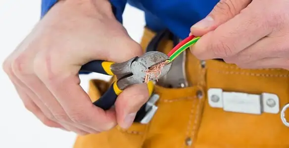 licensed electrician securing electrical wiring with professional tools during service work in Pasadena, CA