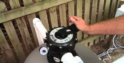 pool pumps service showing professional adjustment of pool pump control system in Pasadena, CA